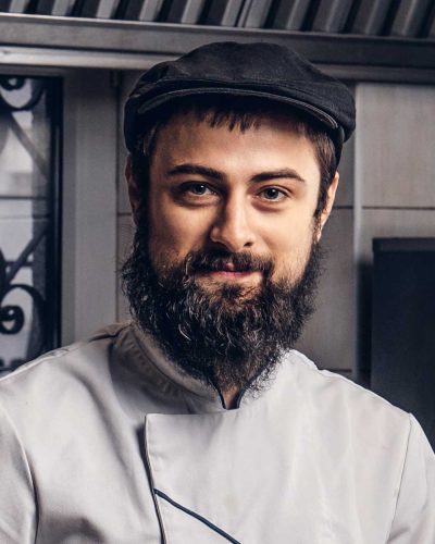 two-smiling-bearded-cooks-dressed-in-uniforms-prep-APMXBQW.jpg